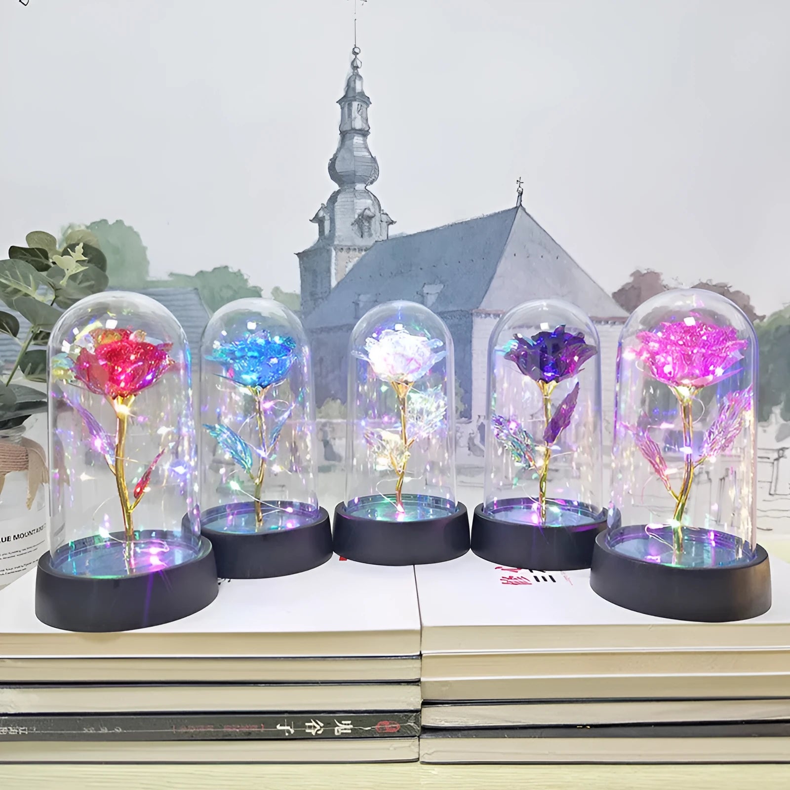 Small decorative night lamp with glass cover, plastic flower, and black base on a pink box.