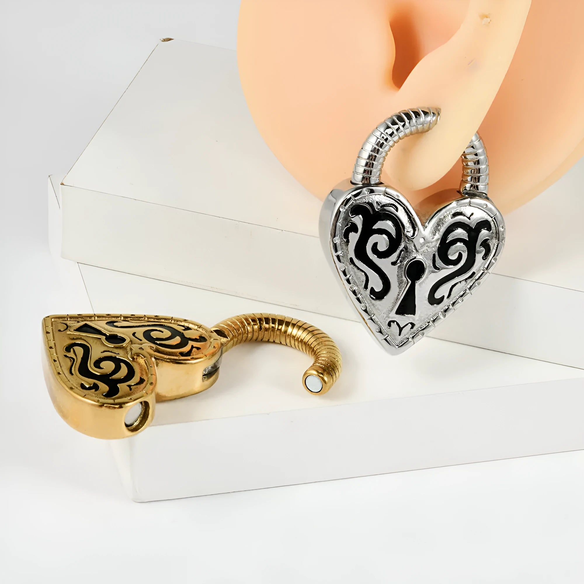 Heart-shaped stainless steel ear piercing stud with electroplated gold finish on white background