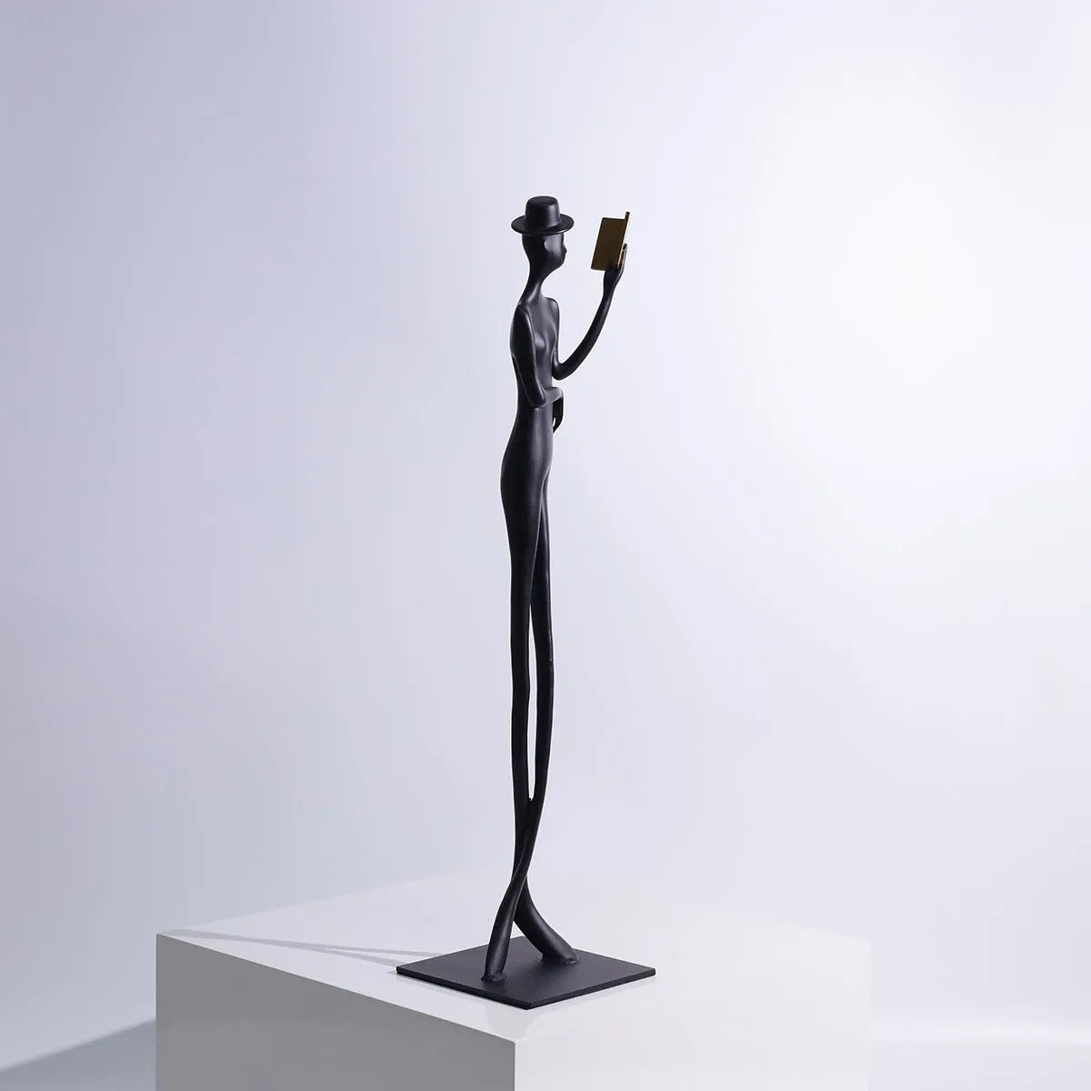Black cast aluminum modern character desktop sculpture measuring 51cm tall.