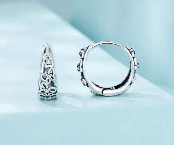 Sterling silver butterfly earrings with hollow retro design and zircon accents
