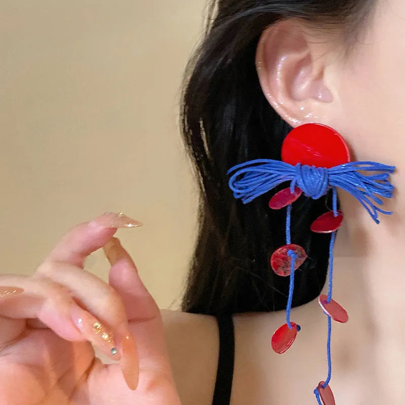 Geometric cloth earrings with blue resin flower detail and round design elements