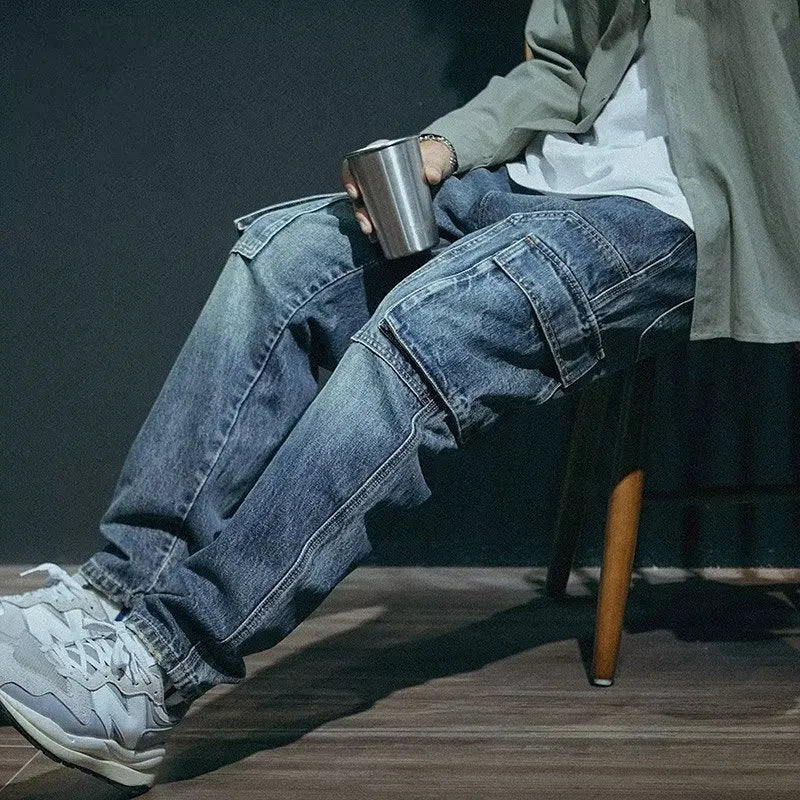 Men's blue loose straight-leg stretch denim trousers with elastic waistband and zip fly placket