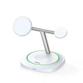 White three-in-one magnetic wireless charger with phone, earphone and watch stands on a desk
