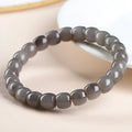 Natural Smokey Violet Hetian Jade straight cut bracelet with 8x9mm stones on a wrist.