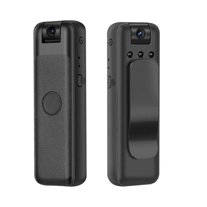 Black USB webcam on a desk with its sliding privacy cover partially closed over the lens.