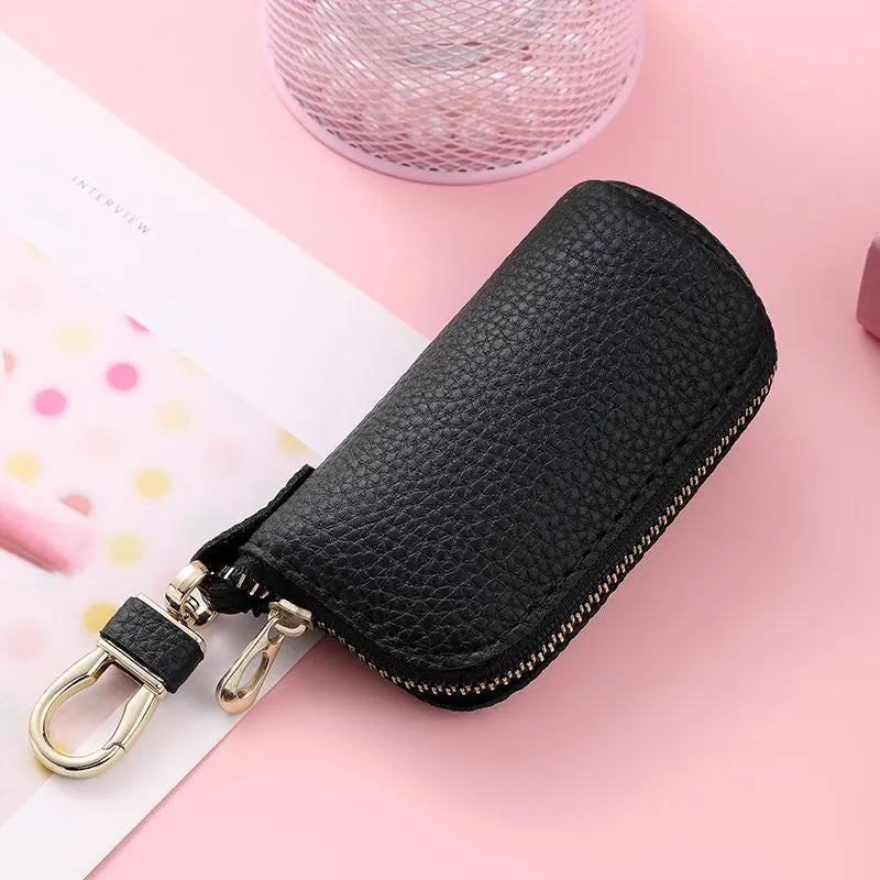 Men's fashion simple black PU leather zippered key ring case on a grey background.