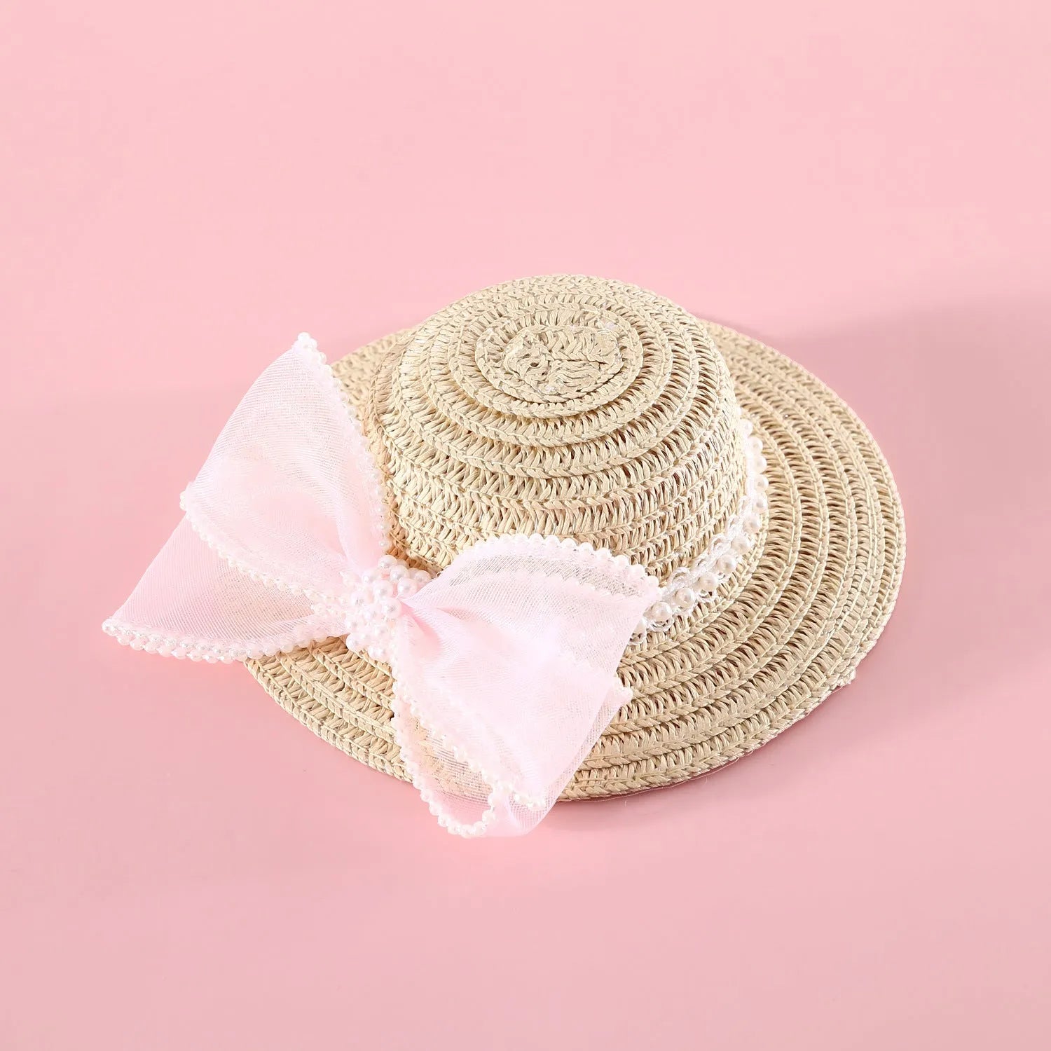Woven straw hat for a cat with a large central pearl bow, available in blue, pink, purple, and white.