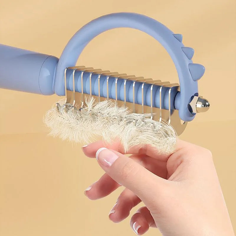 Dinosaur-shaped cat brush with stainless steel pins for self-cleaning pet grooming