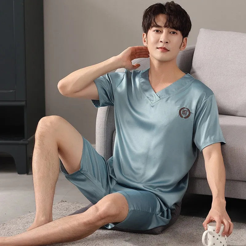 Man's light blue ice silk short-sleeve pajama shirt and loose matching shorts laid flat