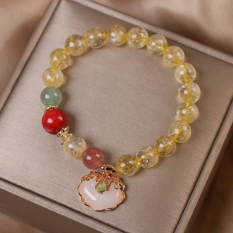 Women's pendant bracelet with a yellow natural citrine jade ruyi charm on an alloy chain.