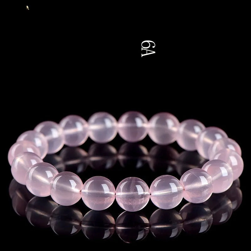Women's natural starlight crystal round bead bracelet in pink, showing polished finish and single circle bead arrangement.