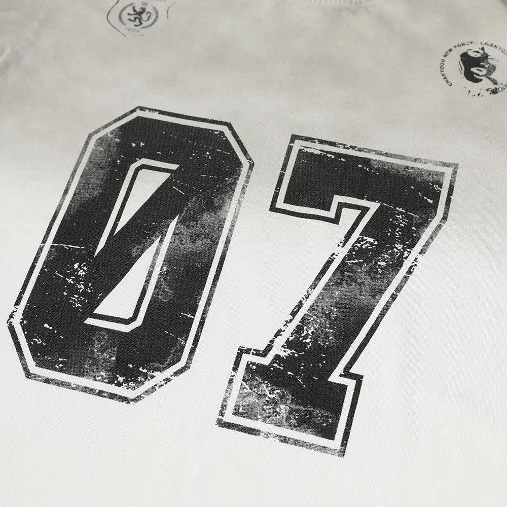 Men's black and white printed short-sleeved cotton t-shirt laid flat, showing sizes S, M, L, XL.