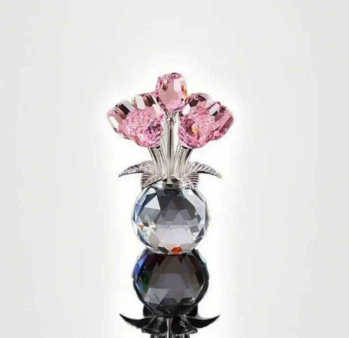 Geometric crystal glass rose ornament in red colour on wooden surface