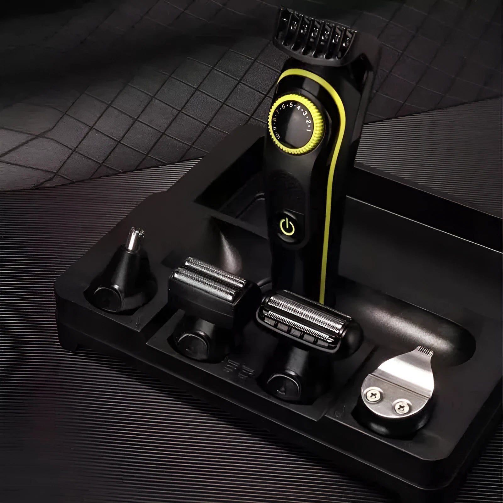 Black household electric hair clipper with USB charging cable and cleaning brush on a white background.