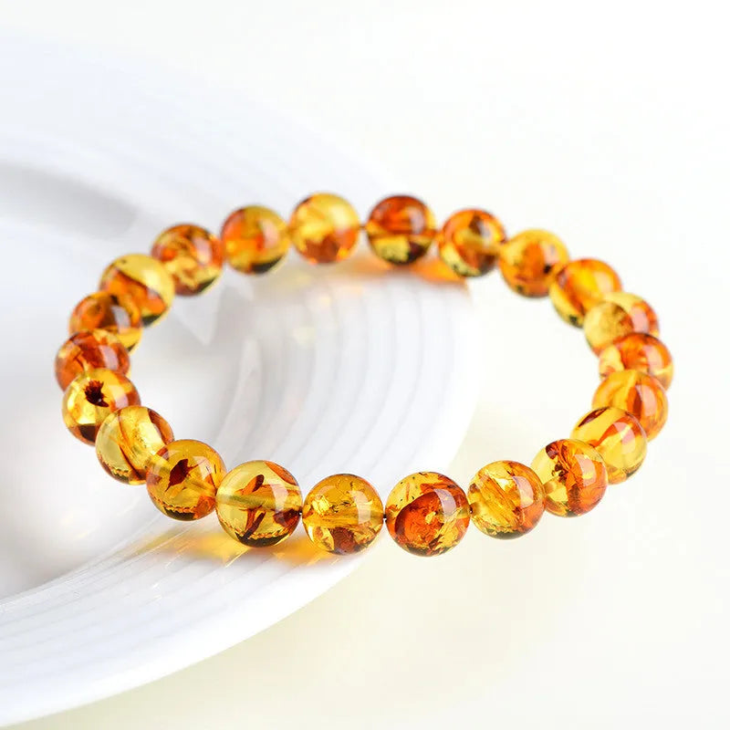 Natural yellow piebald amber bracelet with polished geometry beads and flower spot patterns