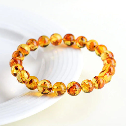 Natural yellow piebald amber bracelet with polished geometry beads and flower spot patterns