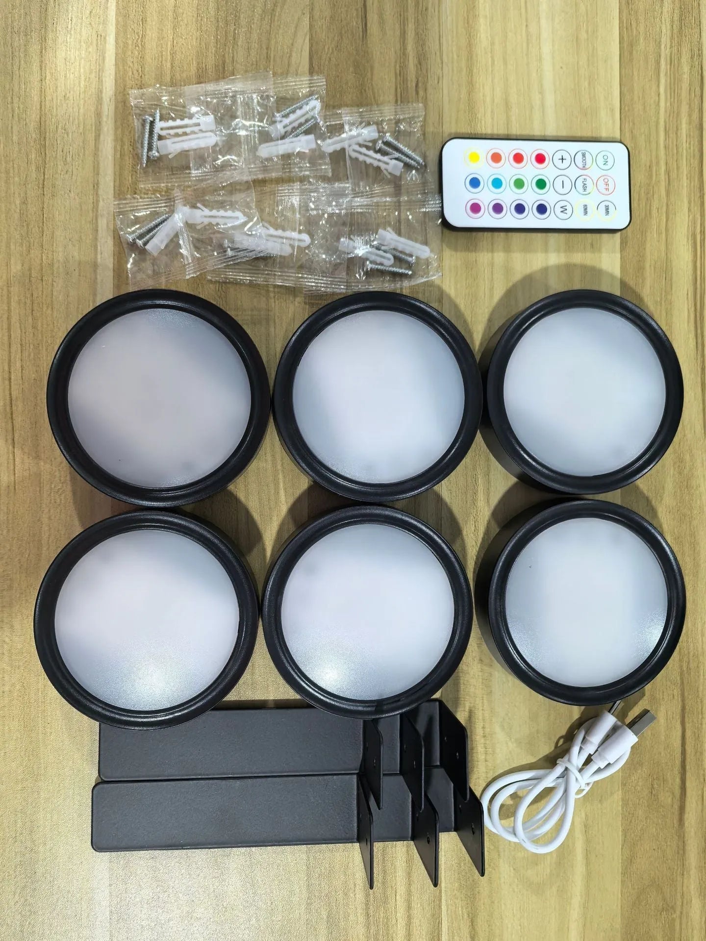 Wireless LED painting lamp with a magnetic mounting belt and remote control in black finish.