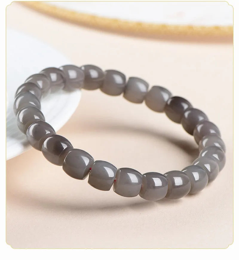 Natural Smokey Violet Hetian Jade straight cut bracelet with 8x9mm stones on a wrist.