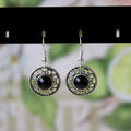 Handmade geometric flower disk earrings in Tibetan silver and turquoise with ethnic Miao design.