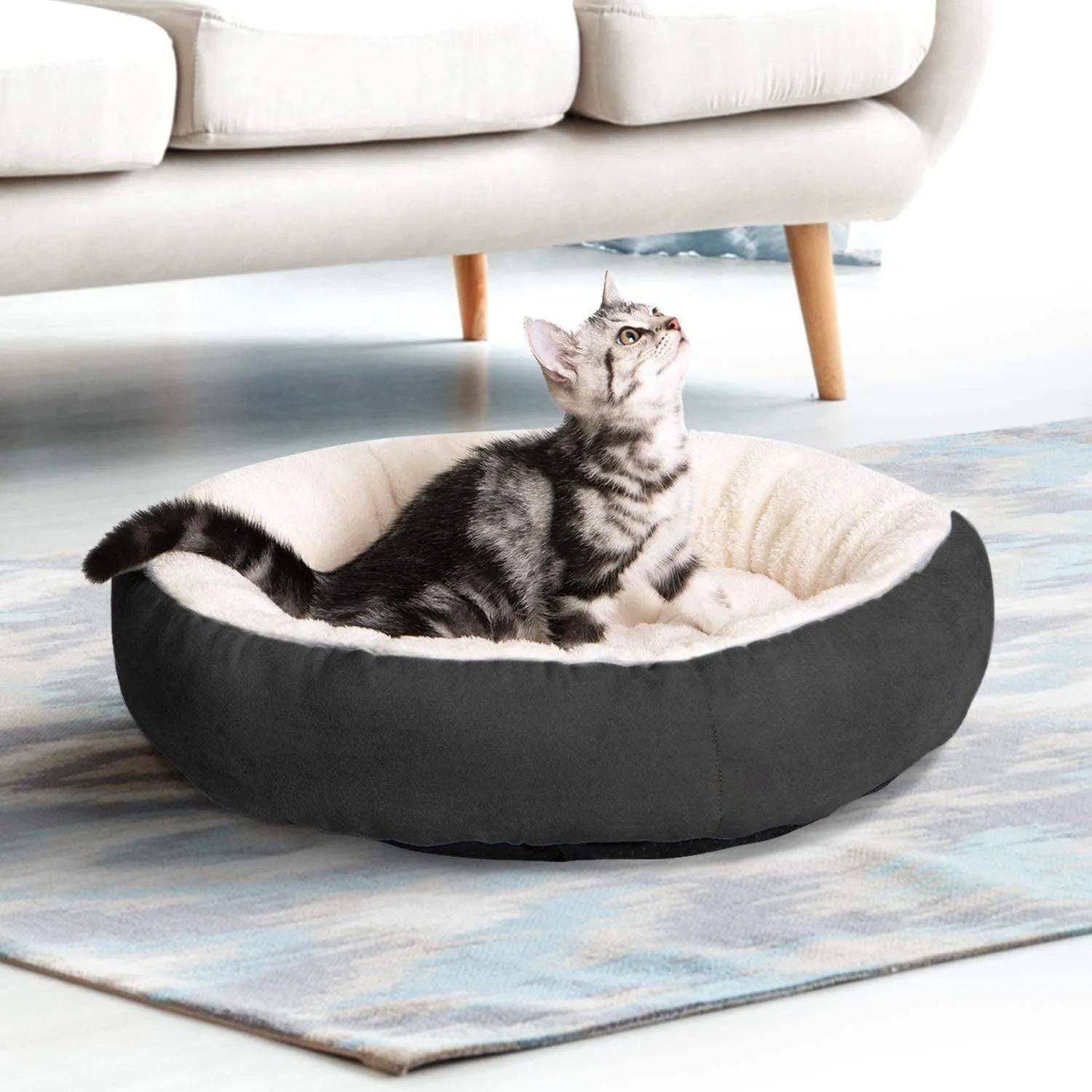 Circular warm soft pet nest dog bed in gray cloth with raised rim, size S, on a wooden floor