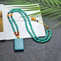 Turquoise stone pendant with hand-woven mesh flower design on adjustable ball bead necklace chain