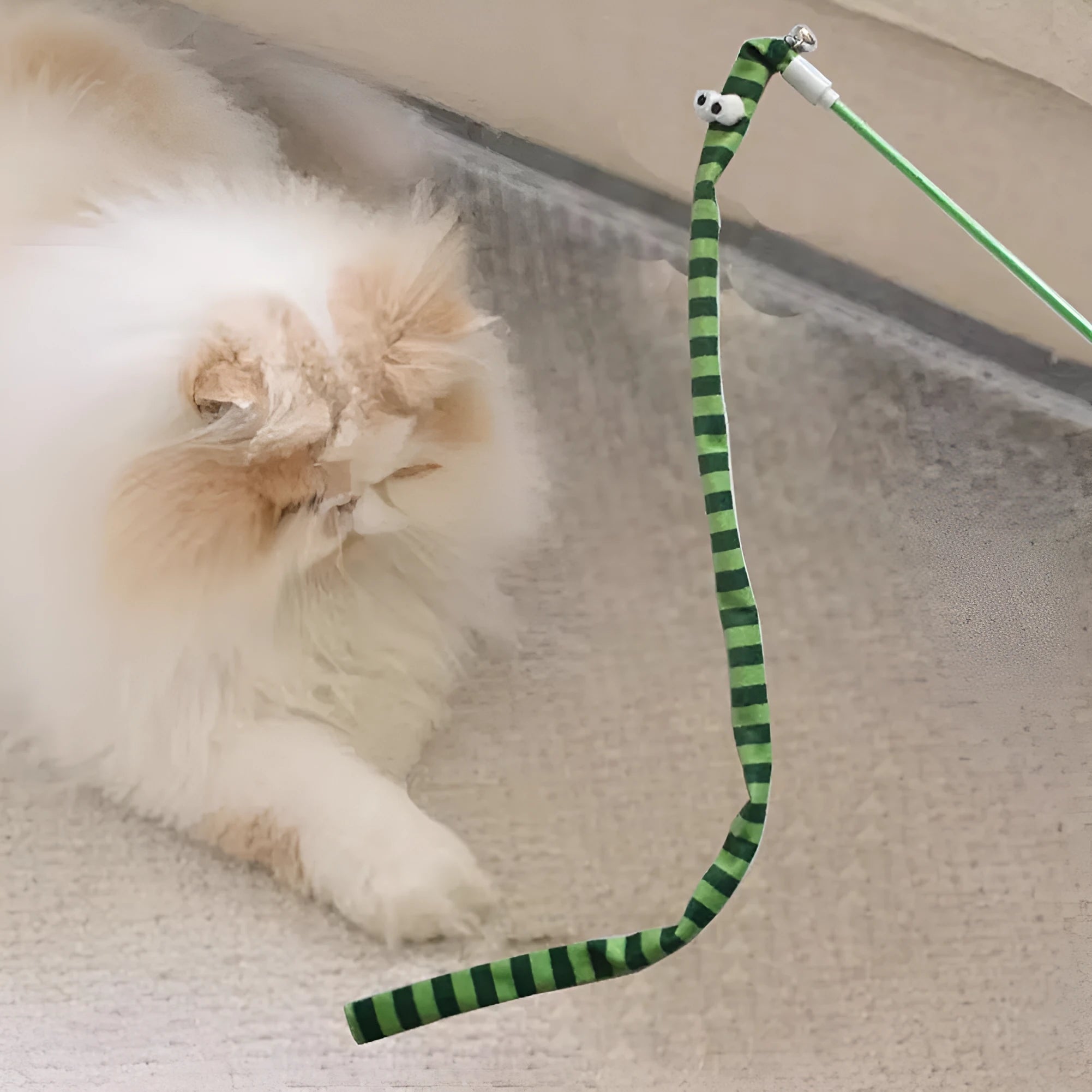 Colourful cat wand toy with a long plush strip teaser and bell, held by a polycarbonate handle.