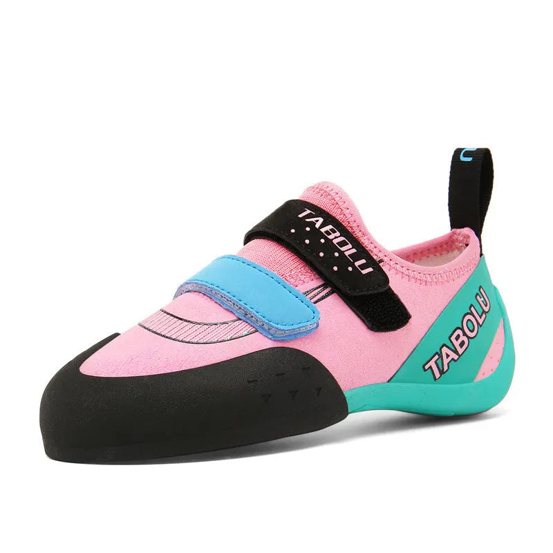 A pair of black and red rock climbing shoes with Velcro straps and a rubber sole.