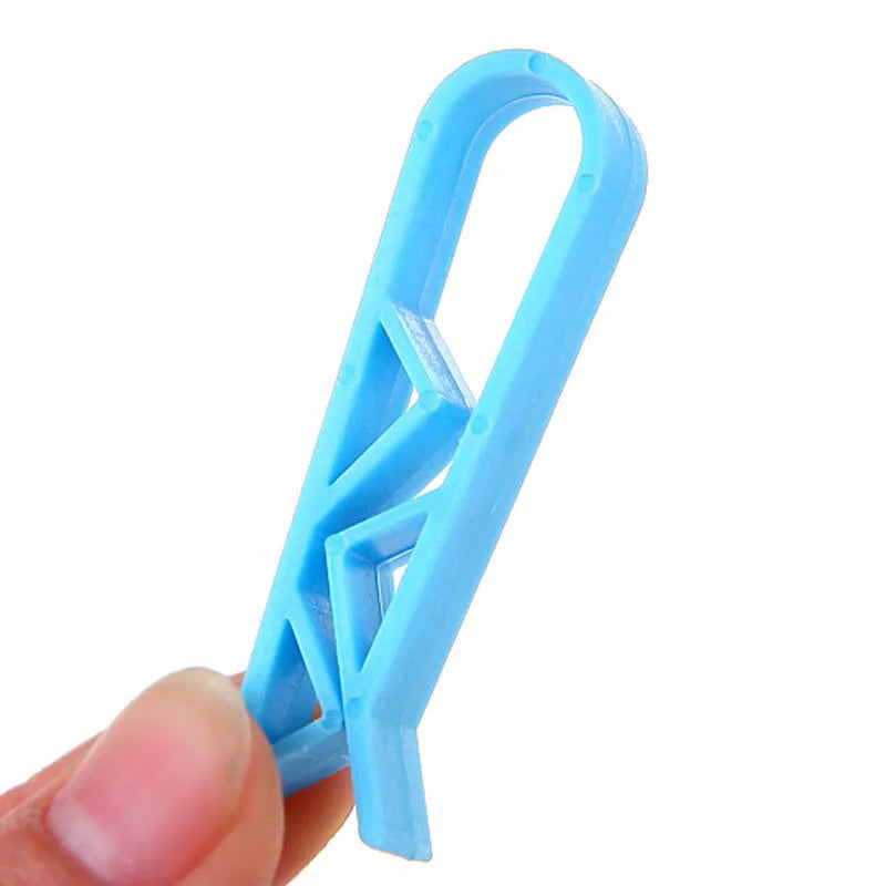 White PP plastic side-fixed clip for holding a bin bag on a trash can rim.