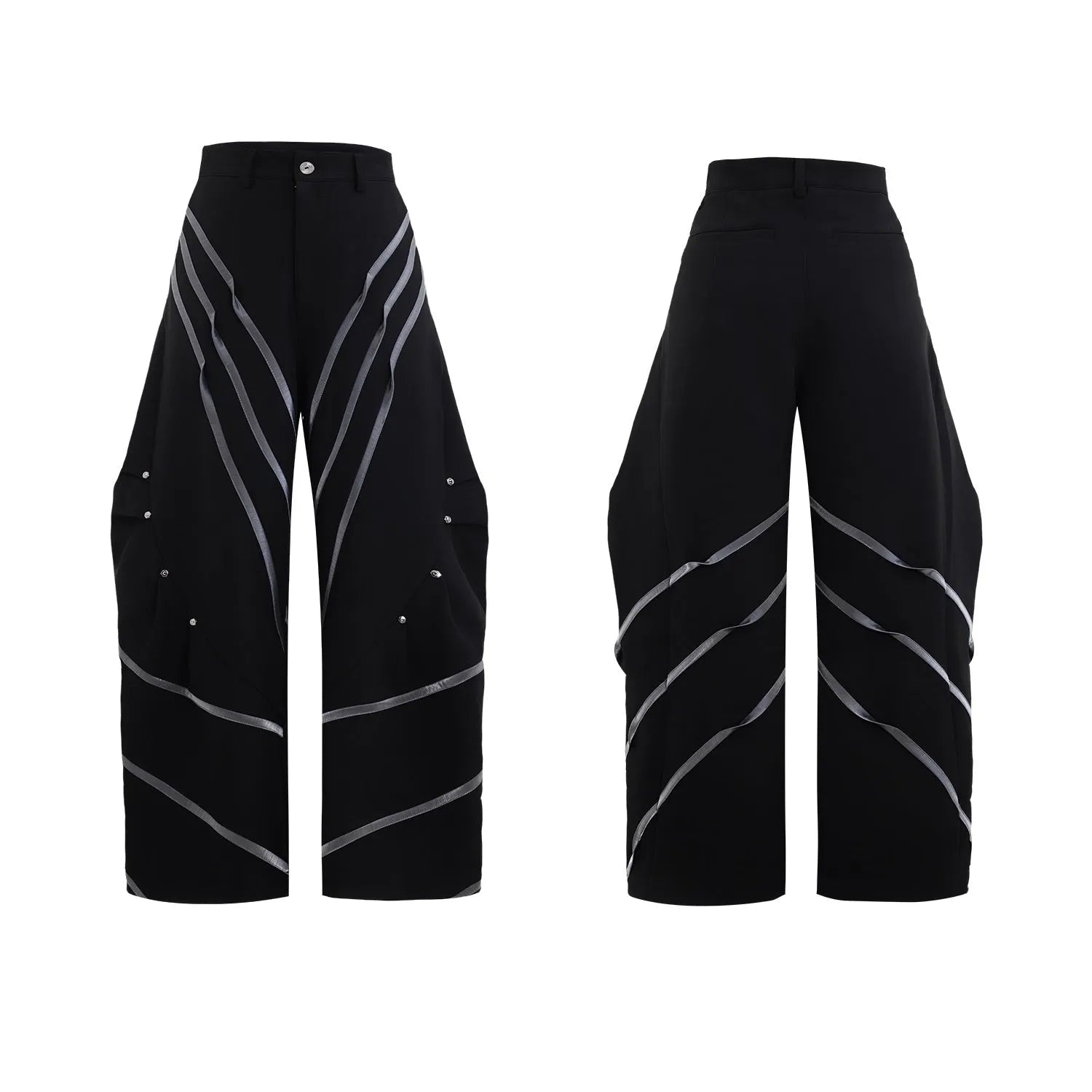 Men's black and white deconstructed trousers with metal striped rivets and front pleats.
