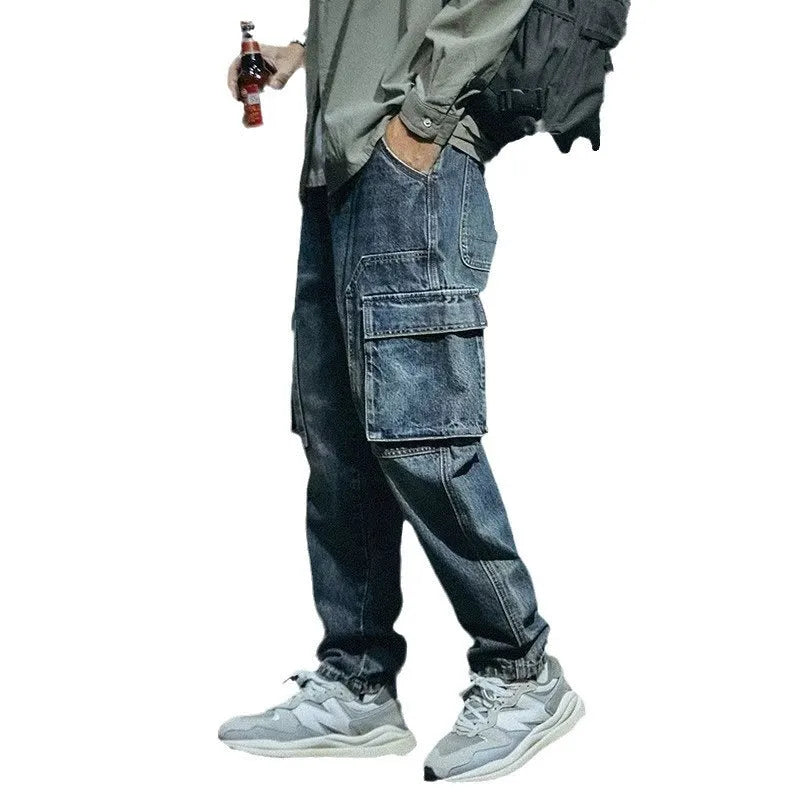 Men's blue loose straight-leg stretch denim trousers with elastic waistband and zip fly placket