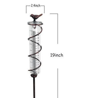 Cast iron outdoor rain gauge with glass hummingbird decoration showing measurement scale
