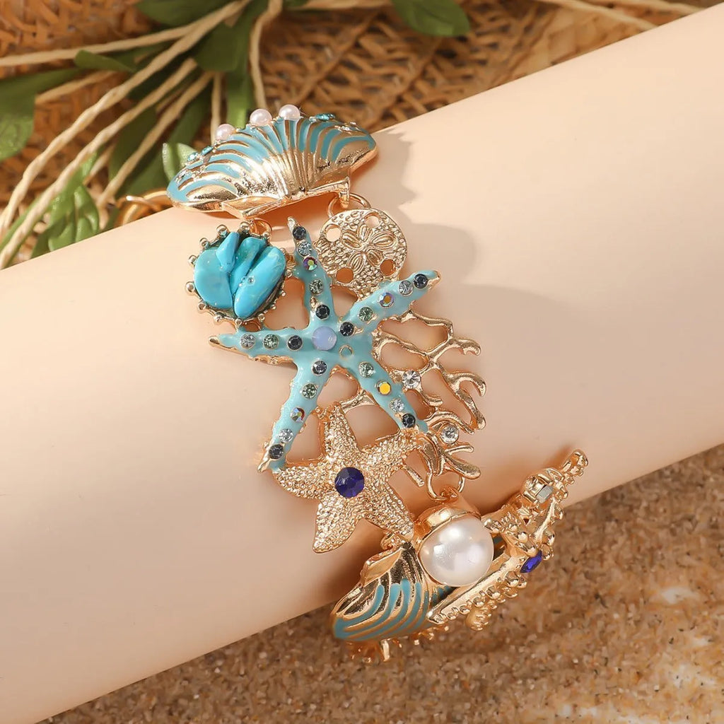 Alloy rhinestone marine bracelet with boat anchor and shell details in blue coral colour