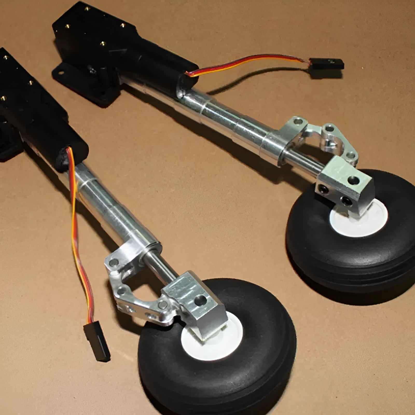 Alloy retractable drone landing gear with shock-absorbing damping system and three wheel size options