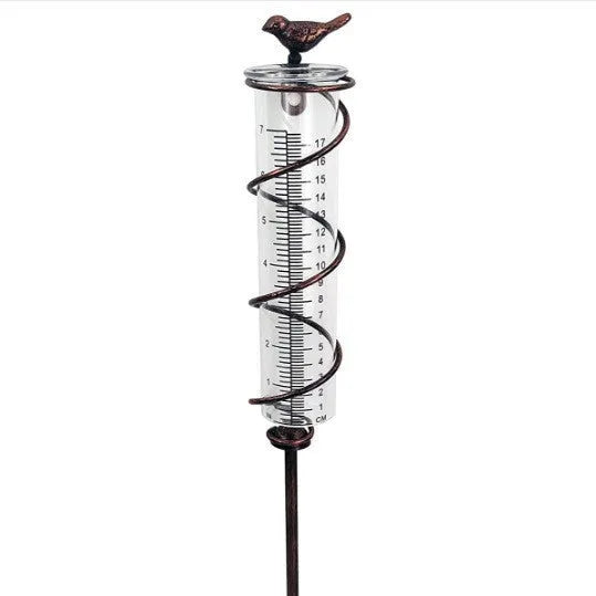 Cast iron outdoor rain gauge with glass hummingbird decoration showing measurement scale