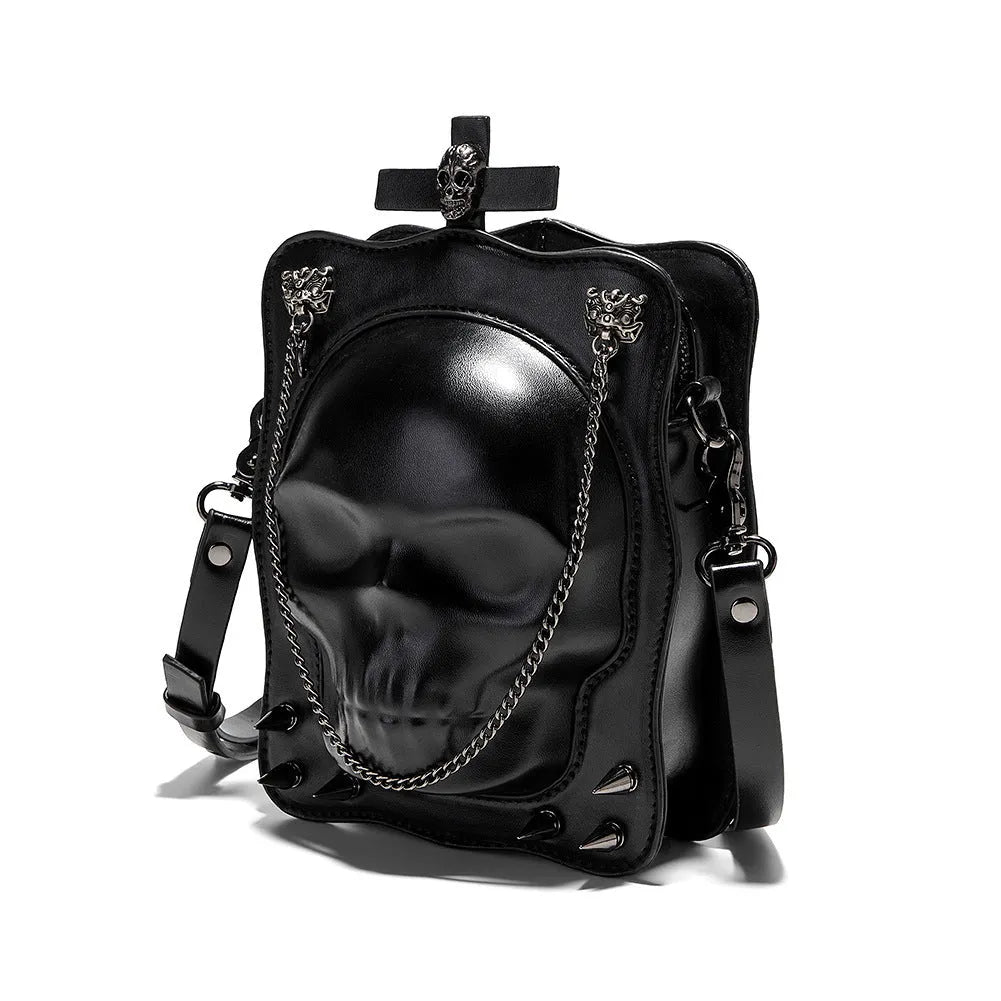 Black Gothic skull crossbody bag with embossed design, square shape, and chain detailing