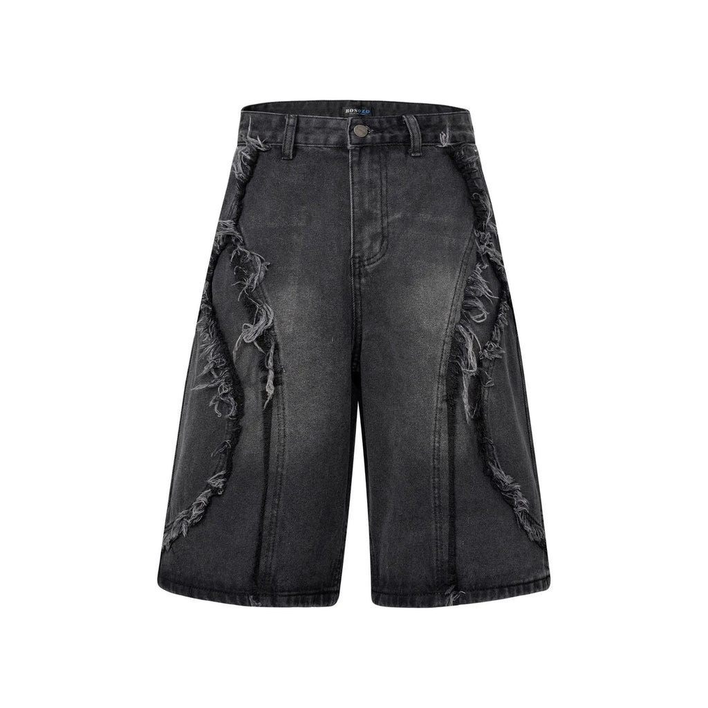 Man wearing distressed light blue denim shorts with raw edge hem and straight hip hop cut.