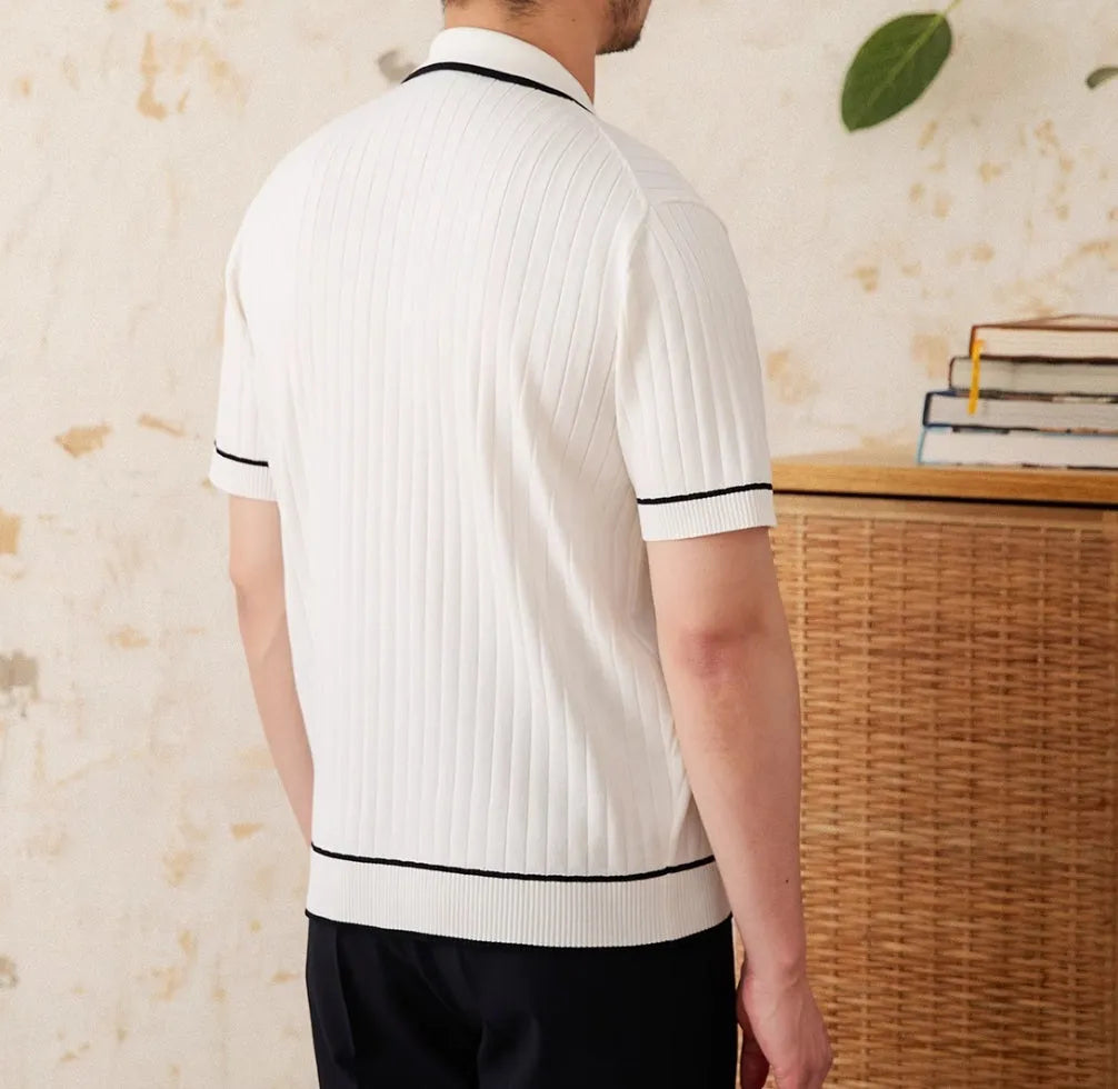 Slim black and white elastic knit polo shirt with lapel collar and short sleeves on hanger