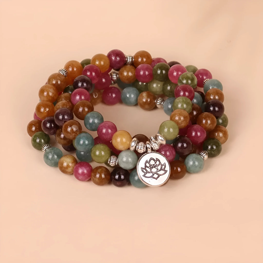 108 bead string bracelet with lotus charm in tourmaline-coloured alloy
