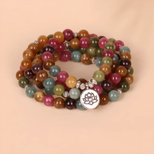 108 bead string bracelet with lotus charm in tourmaline-coloured alloy