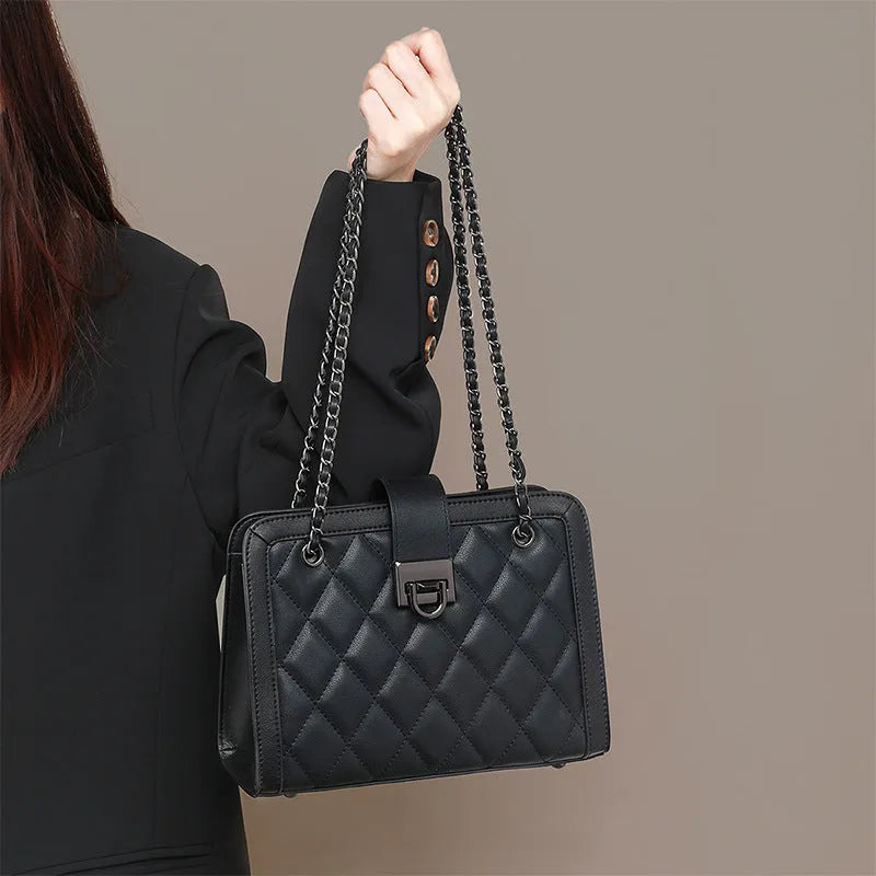 Women's black genuine leather chain crossbody square bag, soft underarm handbag on model