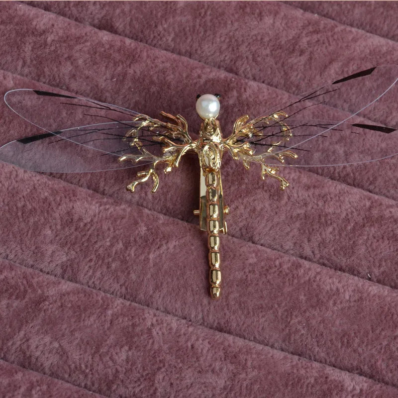 Golden dragonfly-shaped side clip headdress for women's hair, made from alloy with an electroplated finish.