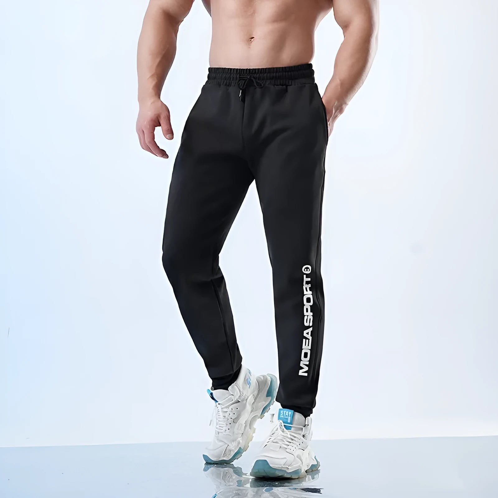 Men's black air layer ankle-tied sweatpants showing mid waist design and adjustable ankle ties