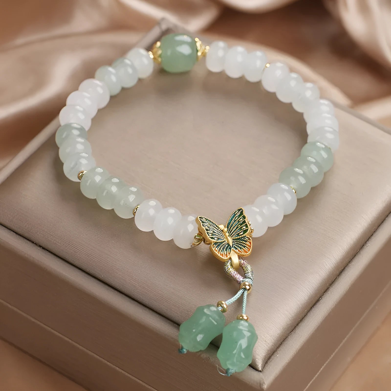 Green crystal Tian Shan Cui abacus bead bracelet with a retro butterfly tassel and pearl detailing.