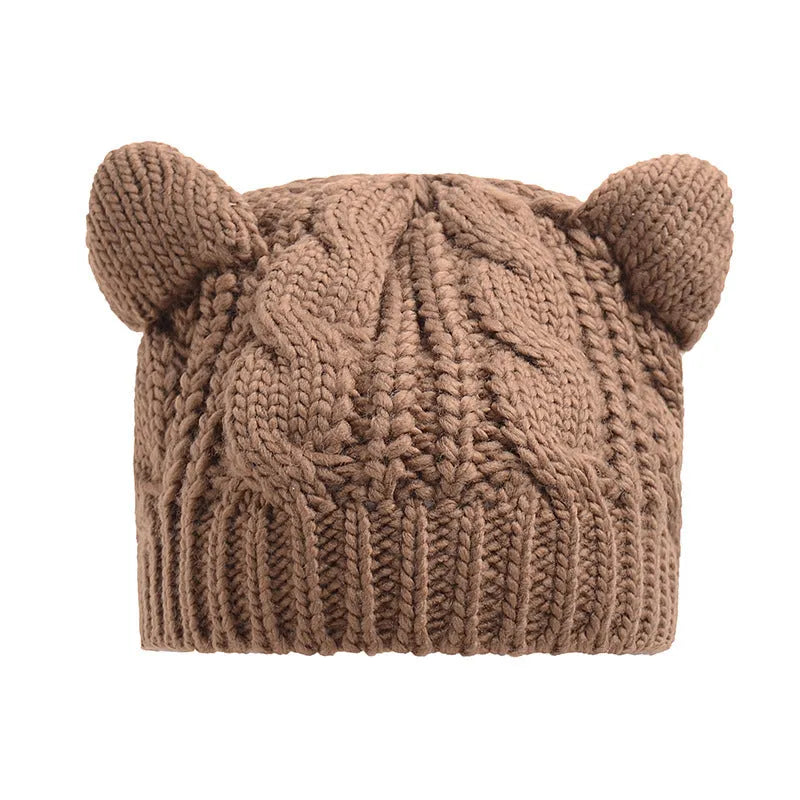Hand made 3D knitted cat ear beanie in wool, shown in multiple colour options including red, black and beige.