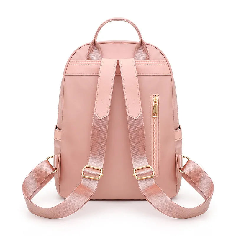 Women's casual backpack in black or pink with 20L capacity, waterproof nylon construction, and internal organiser compartments