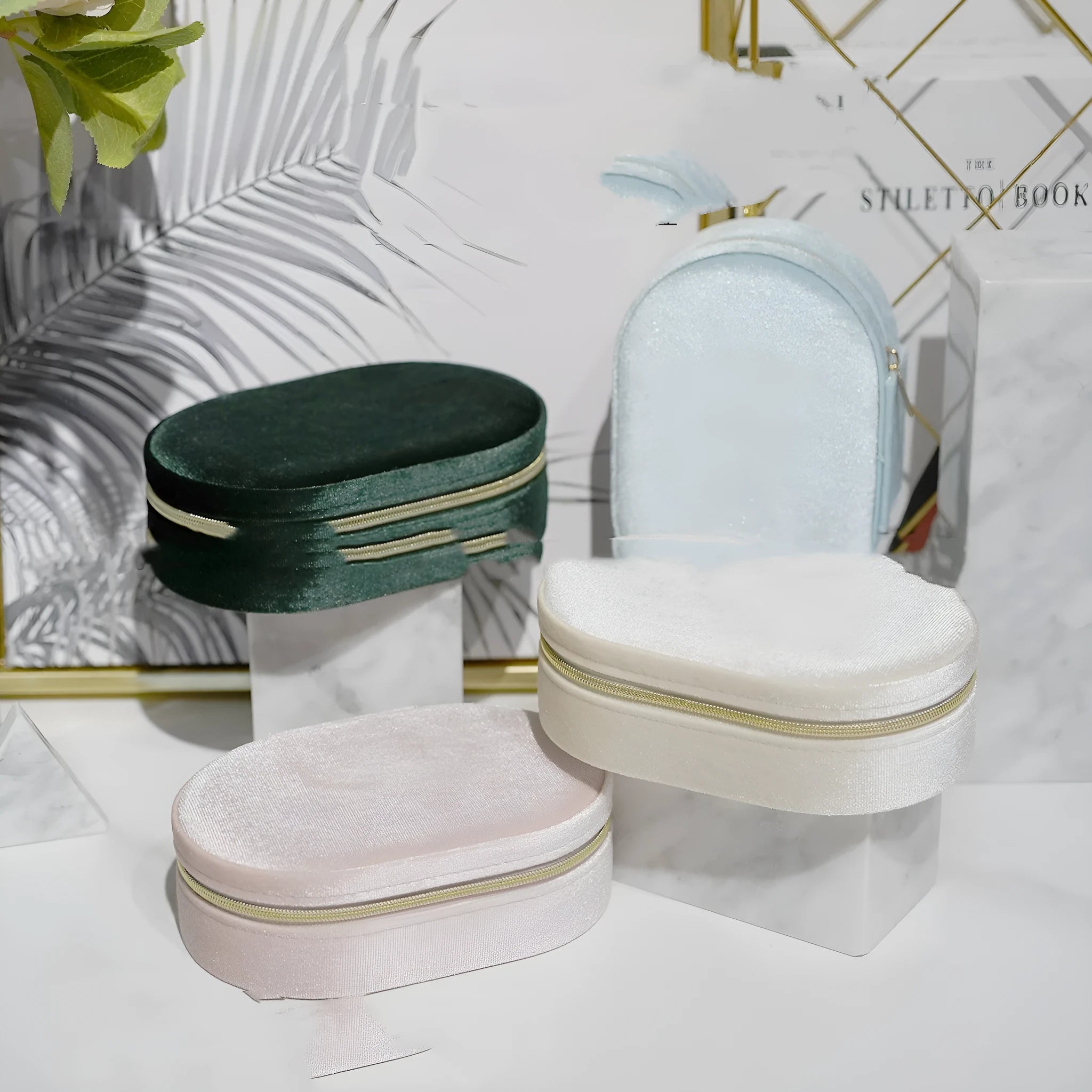 Oval velvet jewellery box with handle in lake blue colour, showing flannel-lined interior.
