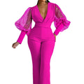 Red mesh stitch long sleeve jumpsuit with elastic waist and wide leg trousers on a hanger.