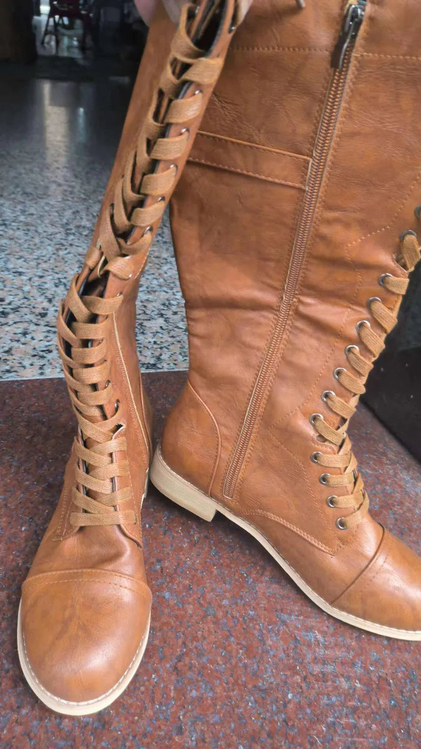 Women's black knight ankle boots with a cross-strap design, made from artificial PU leather.
