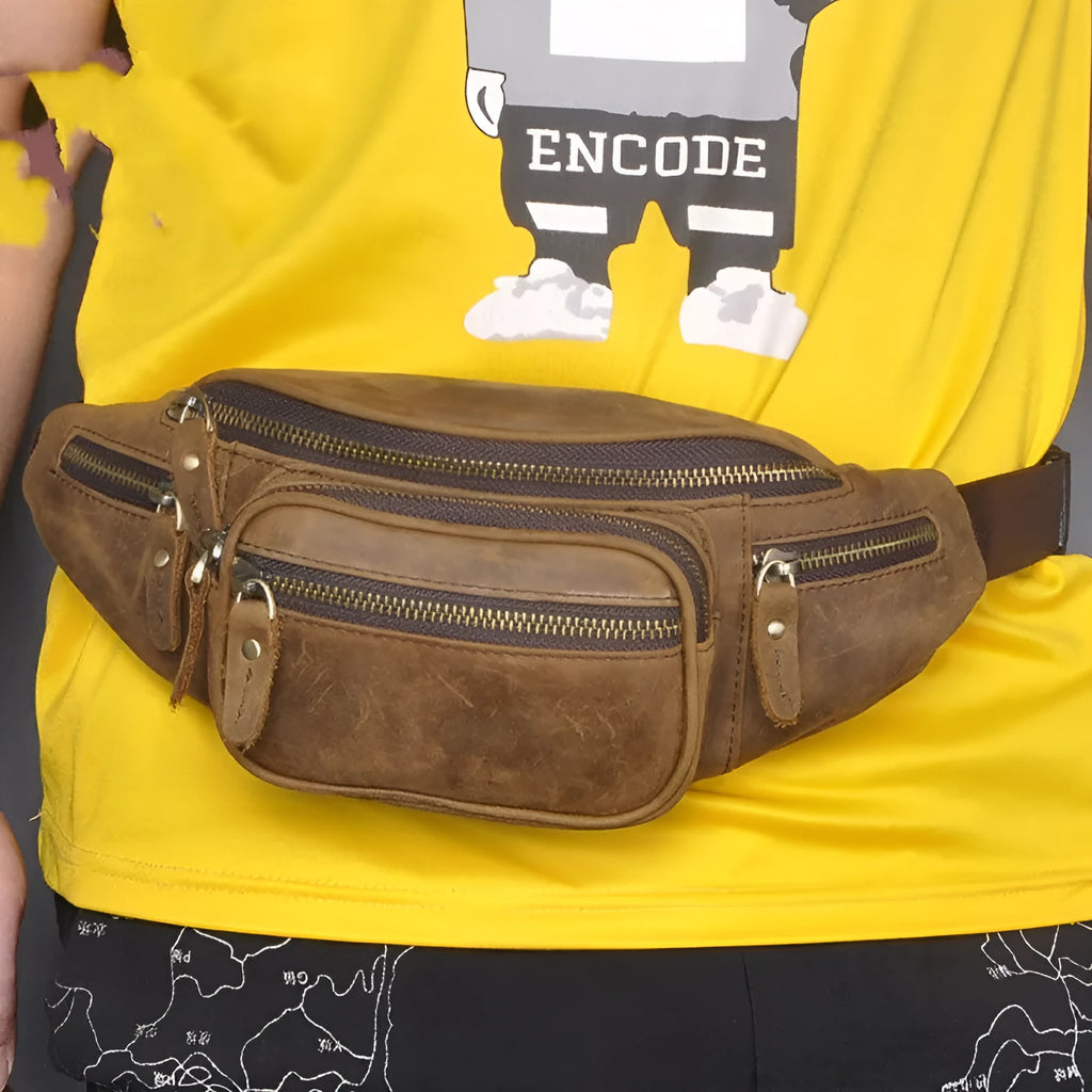 Brown leather shoulder messenger bag with a single strap and magnetic buckle closure.