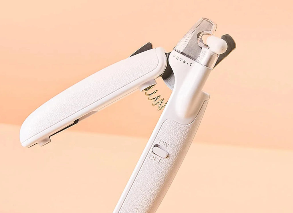 White pet nail clippers with LED light and transparent anti-splash guard for cats and dogs